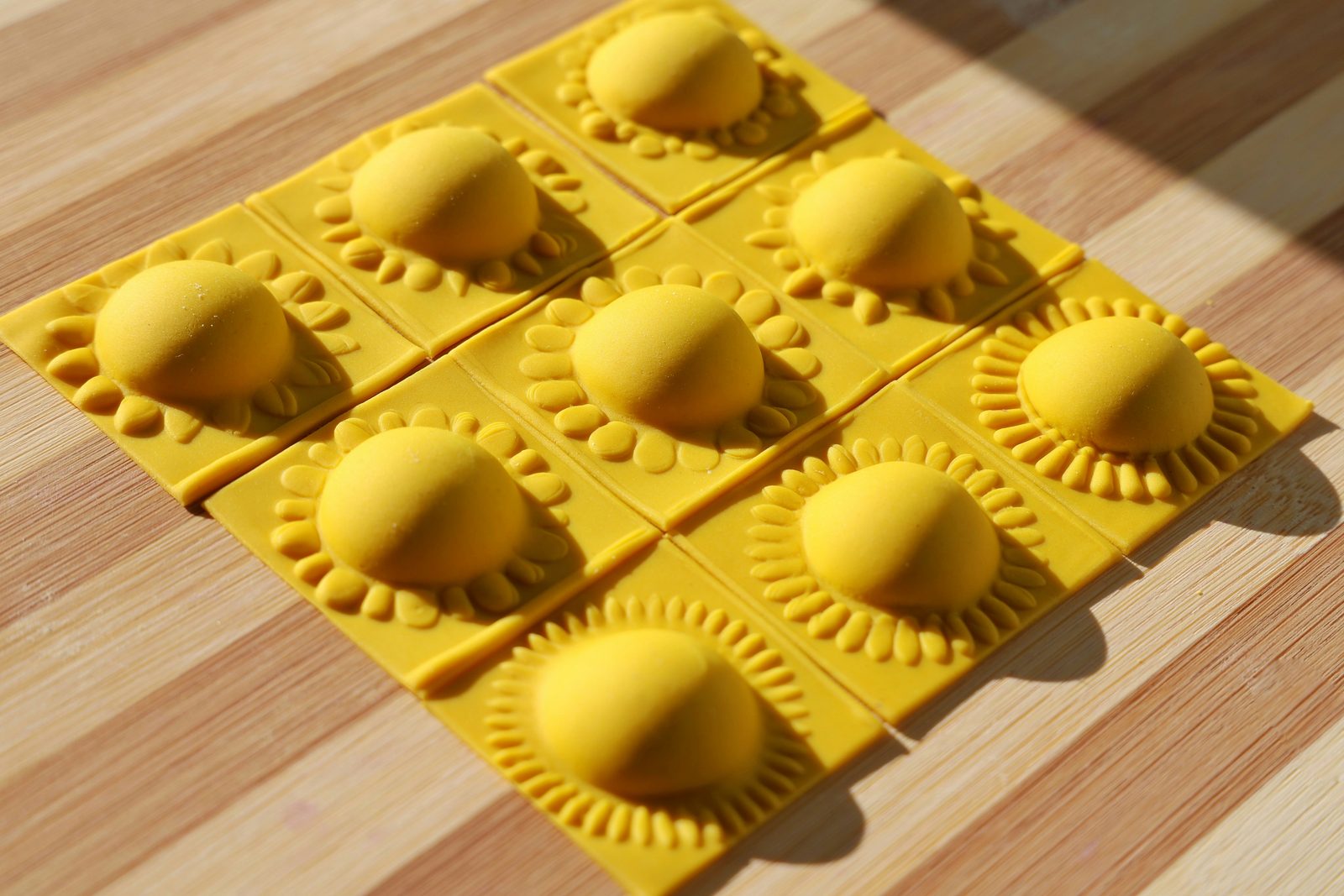 Freshly made ravioli on a wooden board