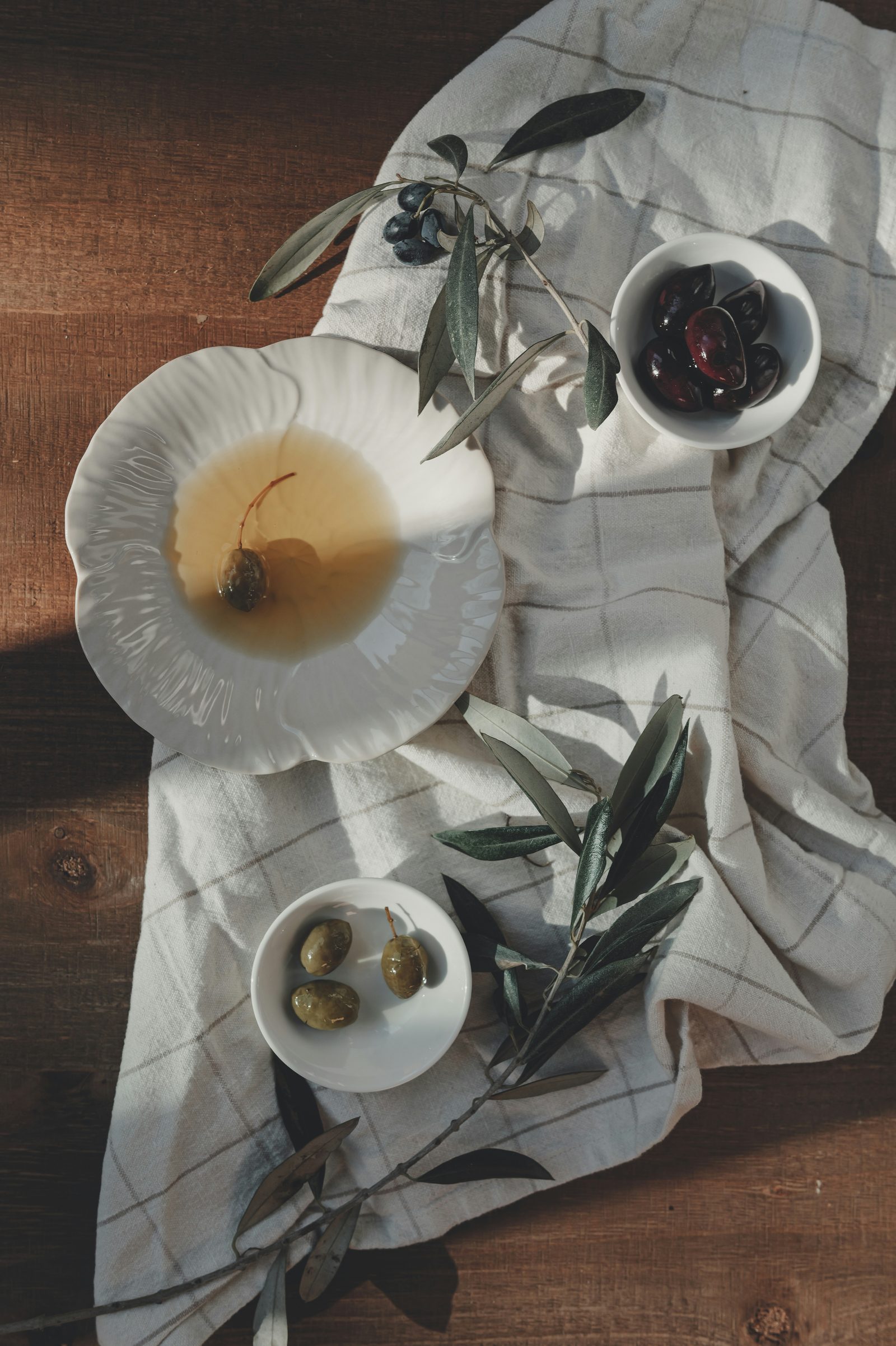 Olives and olive oil on a wooden table
