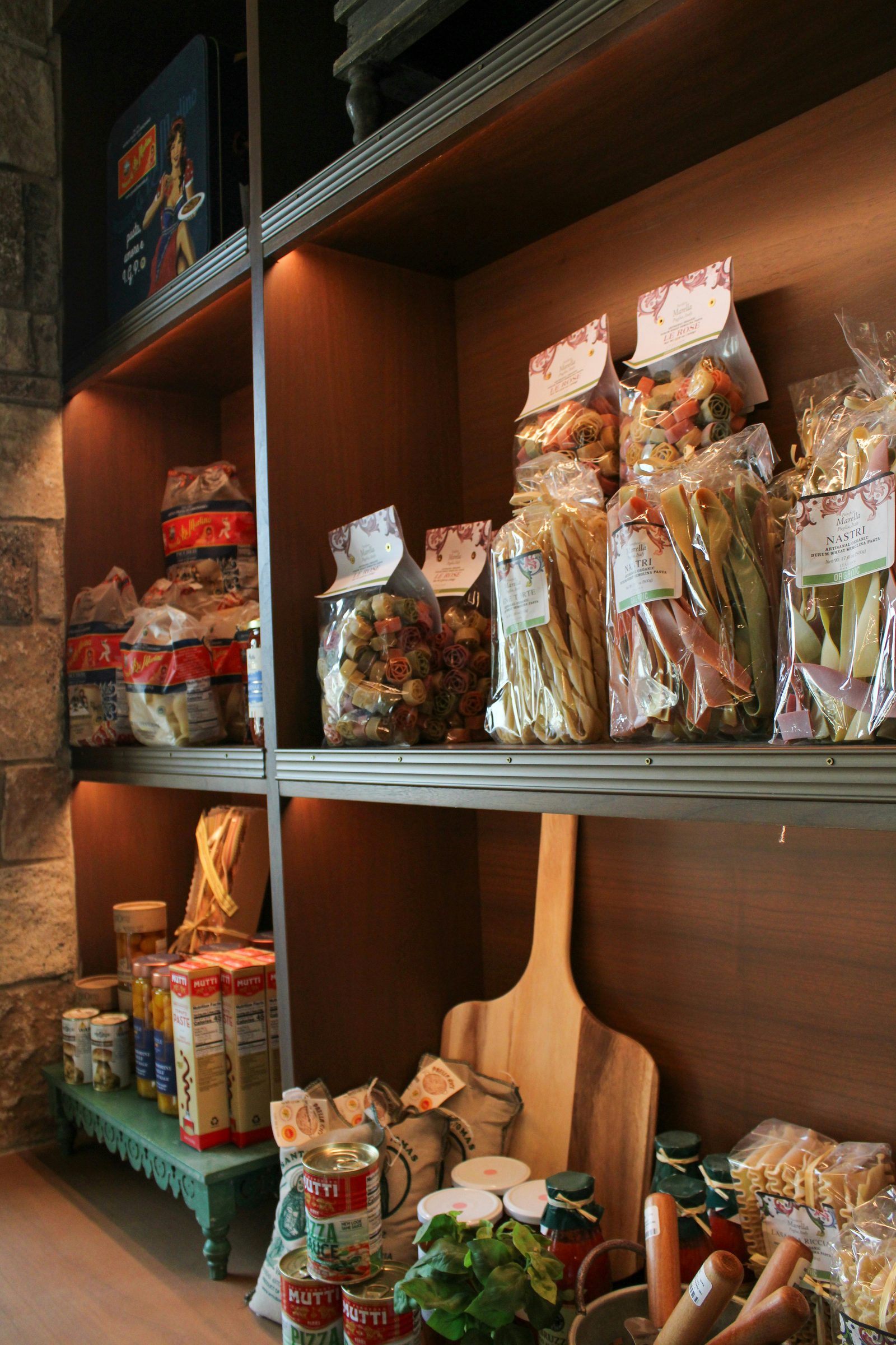 Shelves stocked with pasta and pantry goods