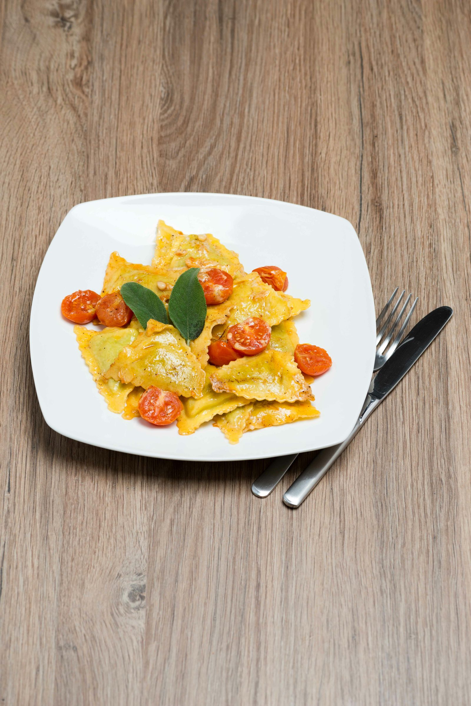 Ravioli with cherry tomatoes and sage